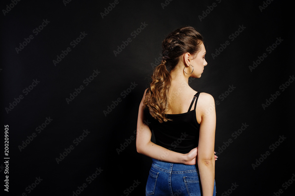 Studio portrait of back hairdress brunette girl on black background. Studio portrait of back hairdress brunette girl on black background.