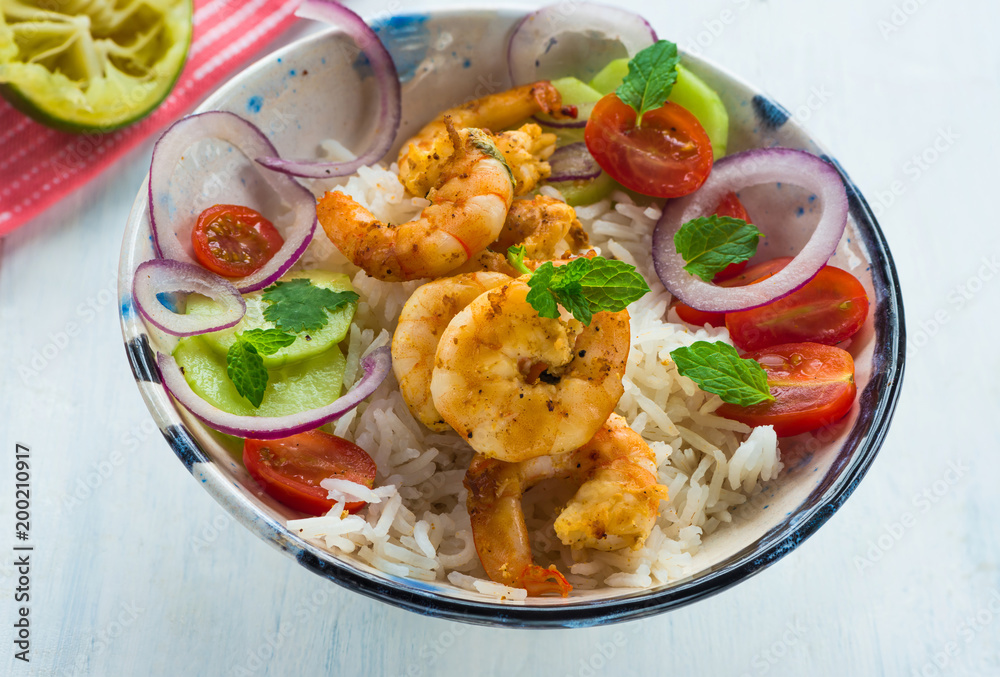 Tandoori prawns with rice and chopped salad - high angle view Tandoori prawns with rice and chopped salad - high angle view