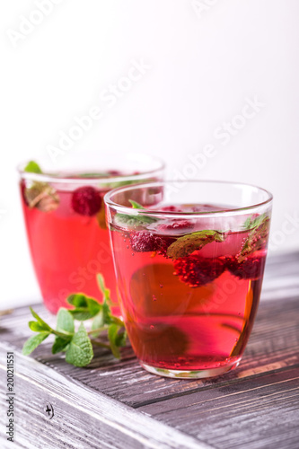 Aperitif with campari, mint and raspberry. Iced lemonade