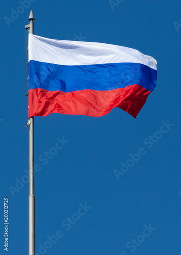 Flag of the Russian Federation against the blue sky