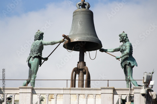 Bell with ringers on St Mark's clock tower in Venice, Italy