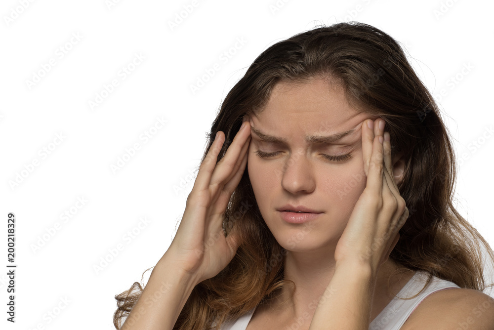 Young girl experiencing headache or depression and mourned over white background Young girl experiencing headache or depression and mourned over white background