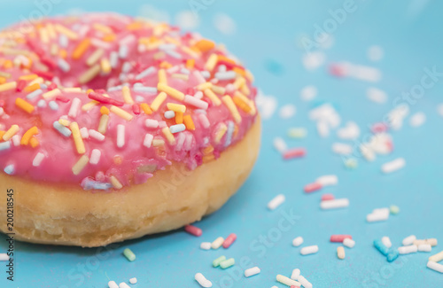 Pink donuts with sprinkles on blue background