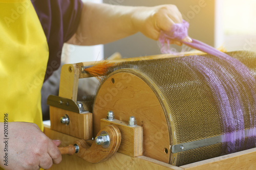 Felting wool. The step of combing the material in a special carding machine.