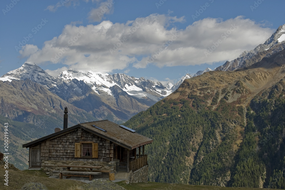 Valais snow covered mountains, small wooden hut or cabin, glacier in background, autumn, sun, clouds, colors, forest, travel, countries of Lotschen, Goppenstein, Jungfraujoch, Bern, Alps, Switzerland