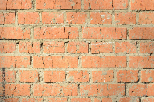 Old orange brickwork with different defects