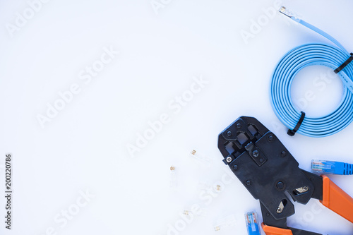 SKS and engineering concept. Set of connectors, ethernet and console cables, crimp tool on the white background. Top view. Space for a text. Close up.