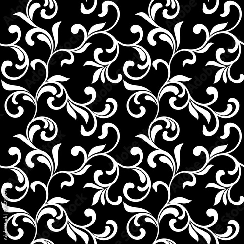 Floral seamless pattern. White swirls and foliage isolated on a black background. Ideal for textile print and wallpapers.