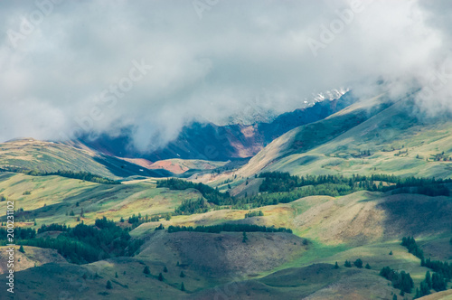 Mountain landscape with clouds. Mountain valley. The Altai mountains. Travel adventure vacation background