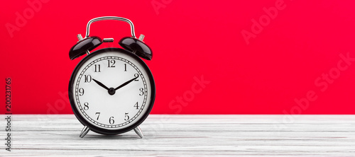 alarm clock wooden plank colored background