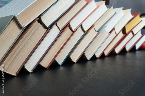 Fotografie Book stacking open book hardback books on wooden table
