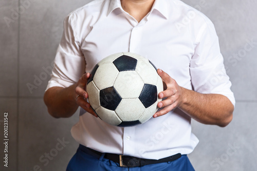 man in a suit with a soccer ball