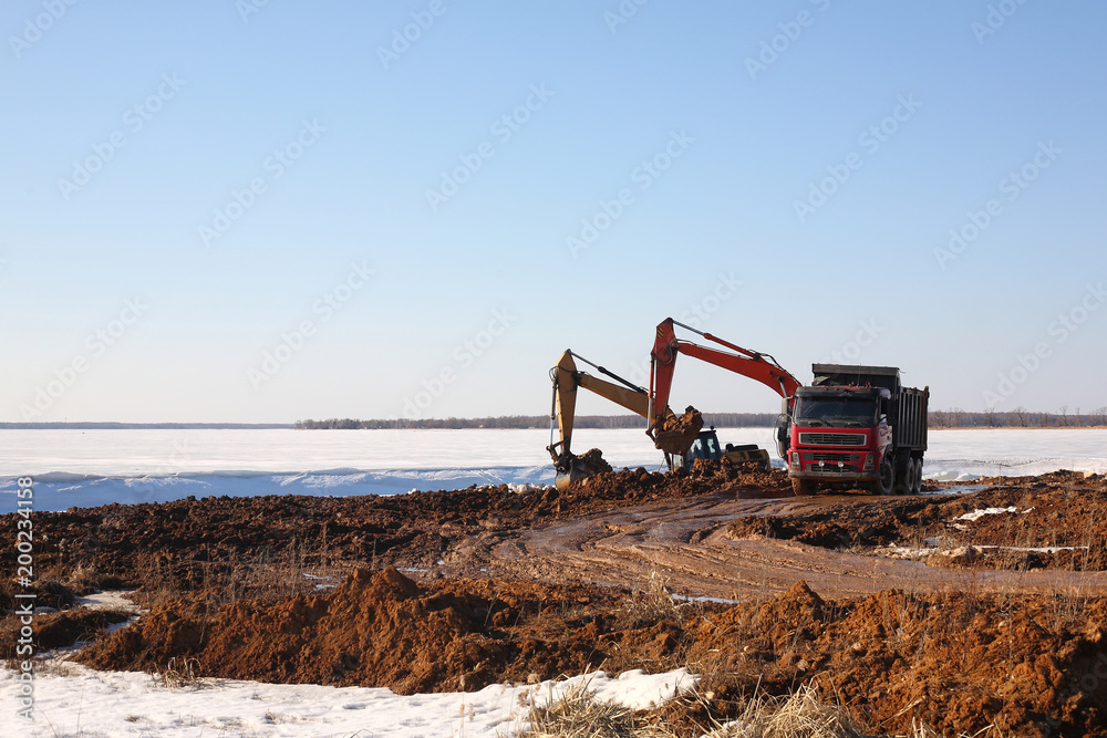 Construction - Two excavator behind dump truck work Construction - Two excavator behind dump truck work