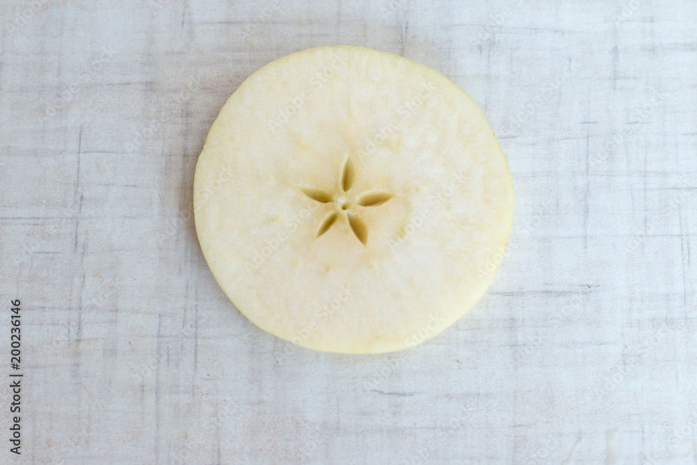 Apple cut into slices, background top view Apple cut into slices, background top view