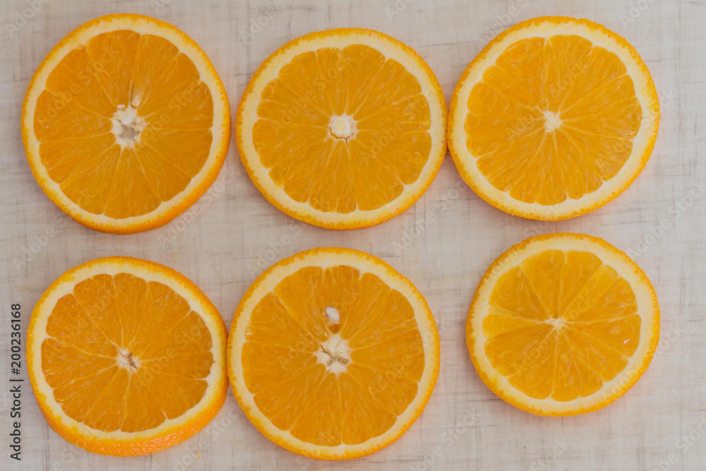 Orange cut into slices, background top view Orange cut into slices, background top view
