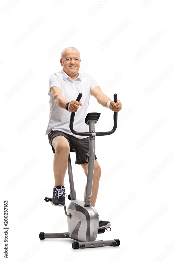 Mature man working out on a stationary bike Mature man working out on a stationary bike