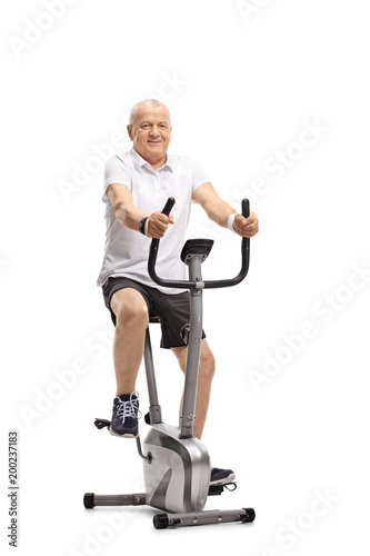 Mature man working out on a stationary bike
