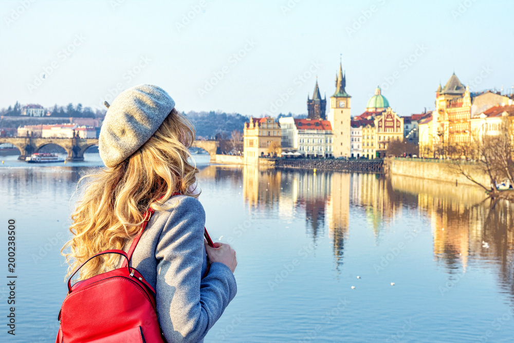 Tourist girl dicovering Prague, Czeh Republic. Charles bridge view on background. Beauty city scape - obrazy, fototapety, plakaty 