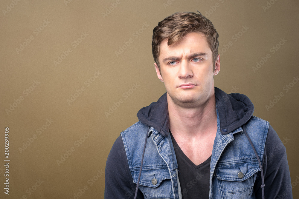 Puzzled thoughtful young man curiously looking at camera Puzzled thoughtful young man curiously looking at camera