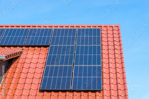 solar panel or photovoltaic plant on a red tiled roof