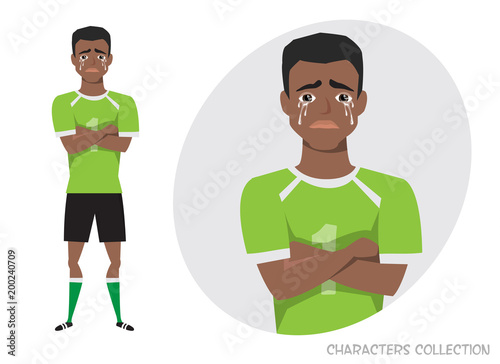 The black african american football player crossed his arms and cries. Mans tears and depression. The emotion of disappointment and sadness at the soccer player face. The male was crying