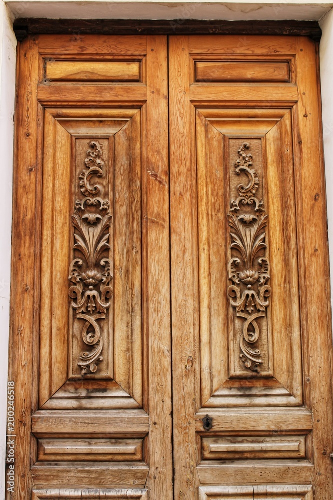 Old colorful carved wooden door in Spain
