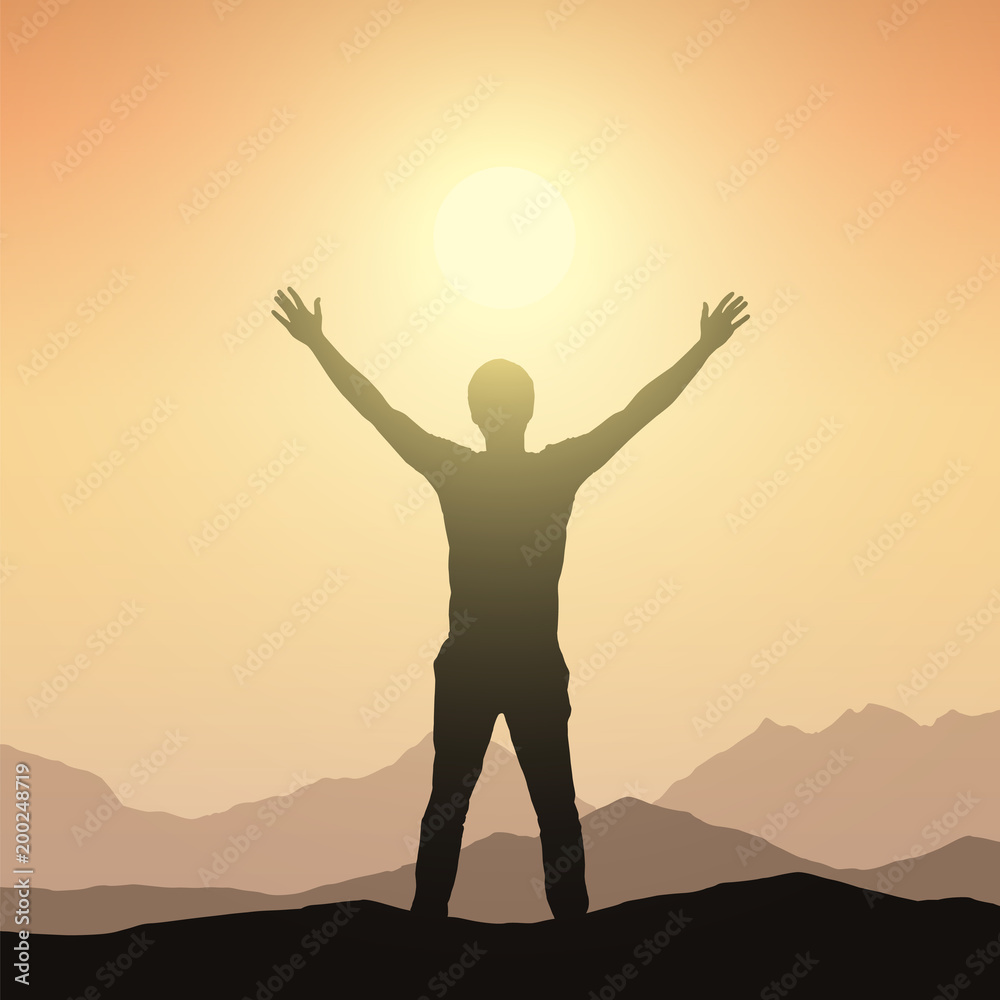 Realistic silhouette of a man welcoming sunrise in a mountain landscape with orange sky