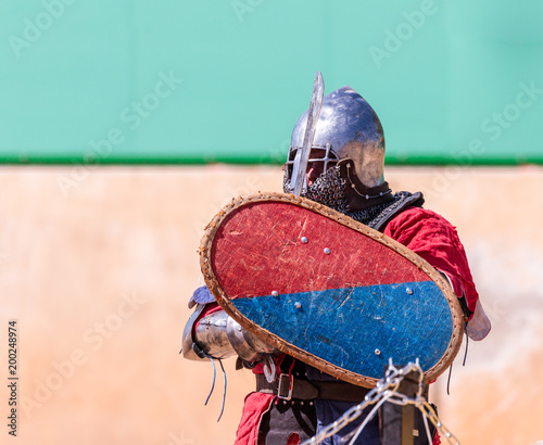 Knight - a participant in the knight festival stands on the list waiting for fight in Goren park in Israel photo