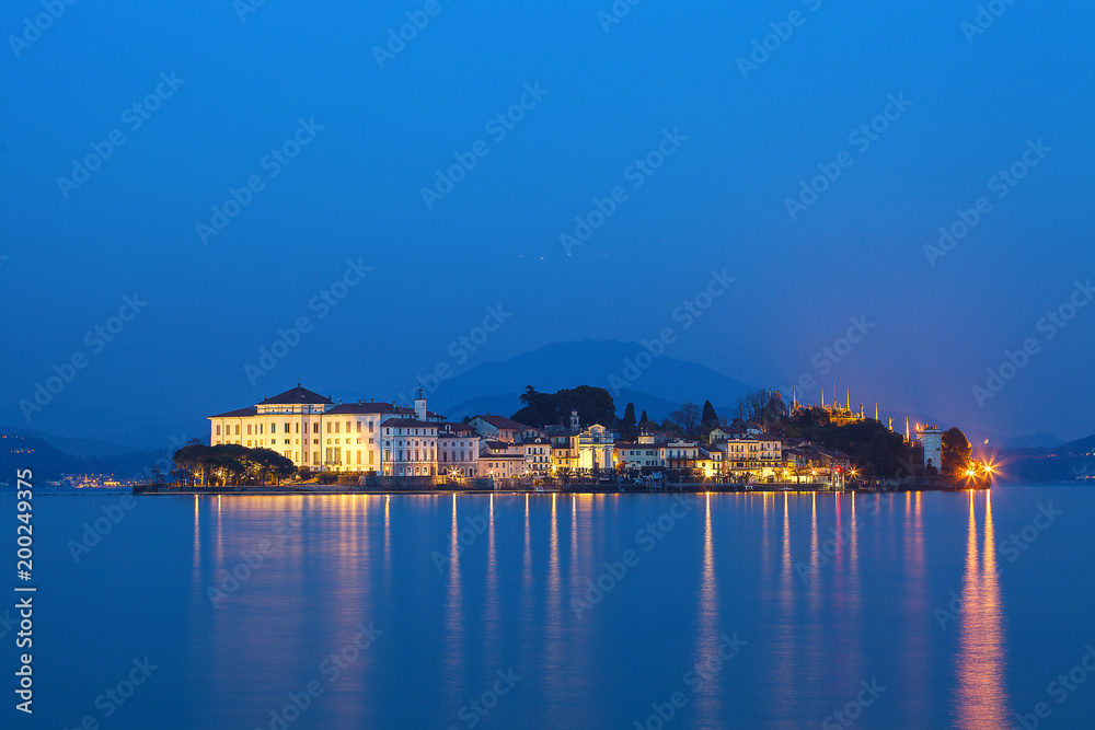 Reflections on the water by the lake at sunset. Isola Bella Island, Lake Maggiore, Italy.