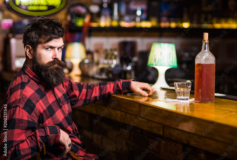 Man with tired face sit in bar or pub