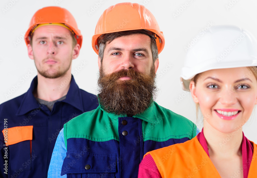 Cheerful team of three constructor workers, men and woman Cheerful team of three constructor workers, men and woman