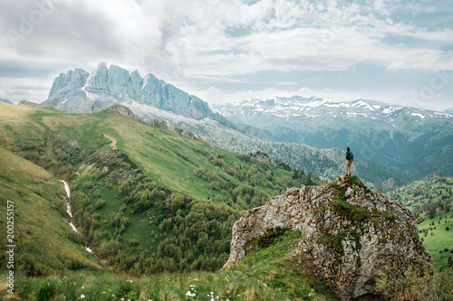 Traveler looking at rocky mountain.