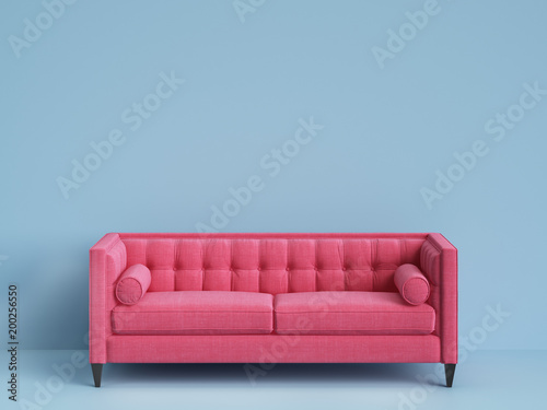Classic tufted sofa pink color on blue background with copy space