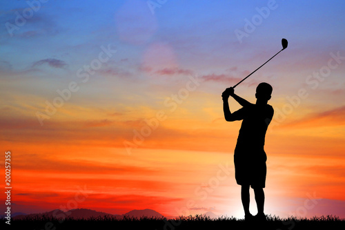 silhouette golfer playing golf during beautiful sunset © rathchapon