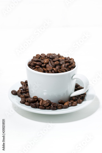 mug with coffee beans on white background, concept photo, vertical