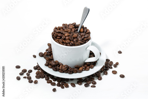 mug with coffee beans on white background  concept photo