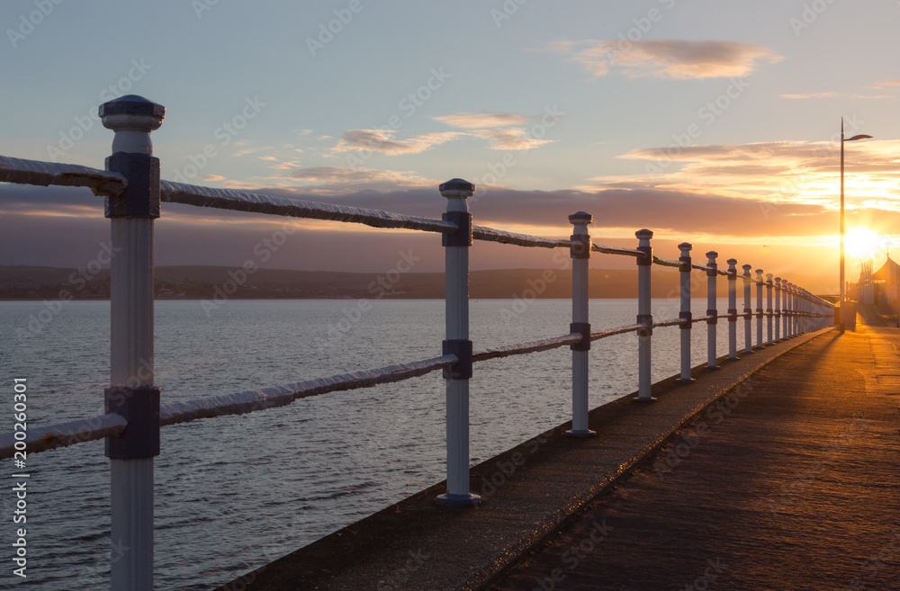 Fototapeta premium Sunrise over the Esplanade in Weymouth at Pavilion and Jurassic Skyline