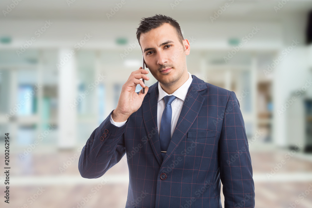 Young hansome realtor using smartphone. Young hansome realtor using smartphone.