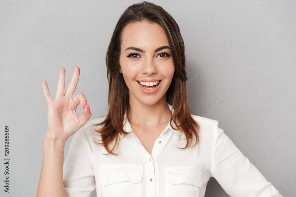 Portrait of a happy young business woman showing ok Portrait of a happy young business woman showing ok