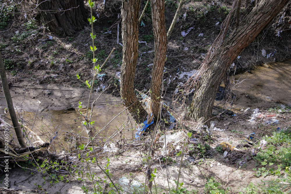 Heavy polluted water stream with domestic garbage Heavy polluted water stream with domestic garbage