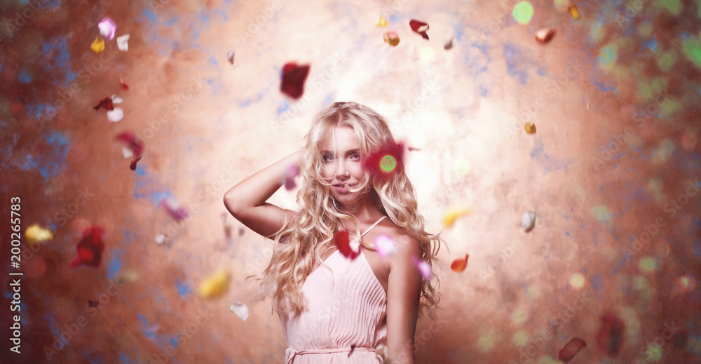 Beautiful young blonde girl in studio in flowers Beautiful young blonde girl in studio in flowers