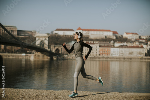 Young female athlete running on the waterfront in Budapest, Hungary