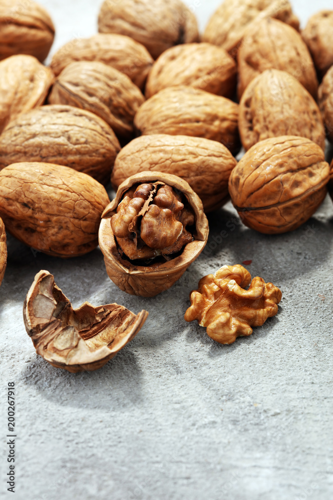 Walnut kernels and whole walnuts on rustic old table Walnut kernels and whole walnuts on rustic old table