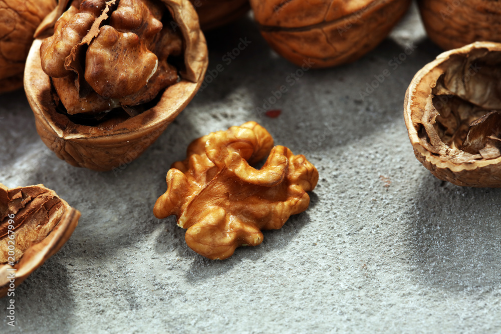Walnut kernels and whole walnuts on rustic old table Walnut kernels and whole walnuts on rustic old table
