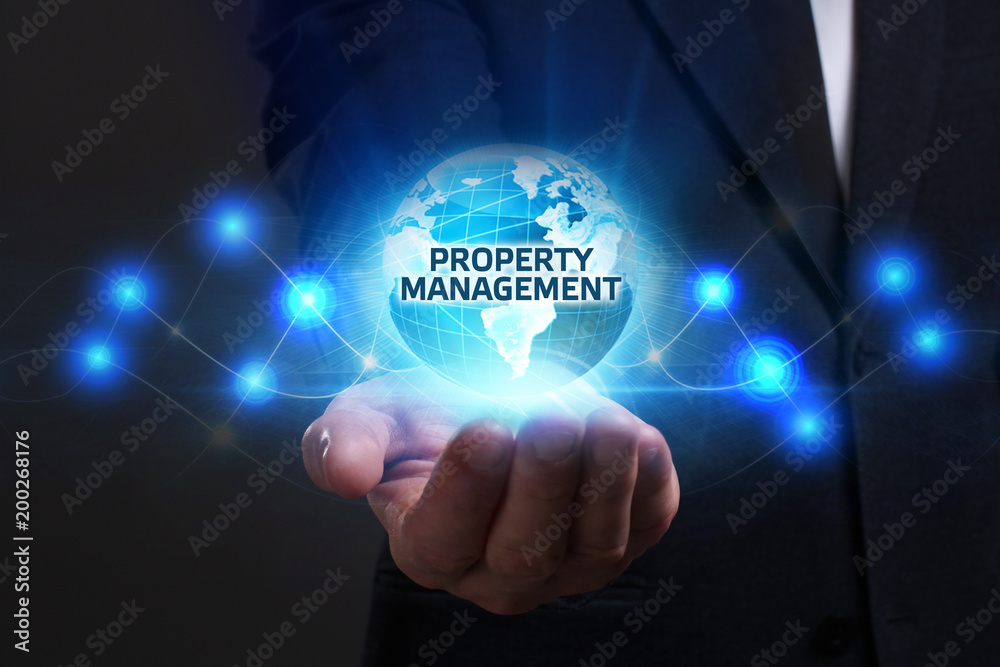 Business, Technology, Internet and network concept. Young businessman working on a virtual screen of the future and sees the inscription: Property management Business, Technology, Internet and network concept. Young businessman working on a virtual screen of the future and sees the inscription: Property management
