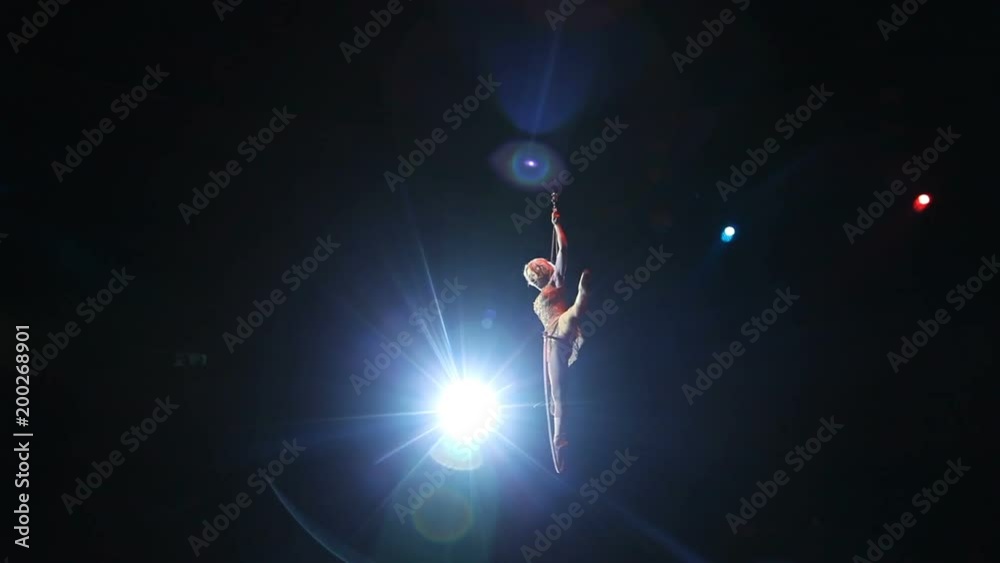 Young girl performs the acrobatic elements in the air ring