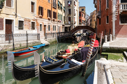 Typical view of gondolas and boats on the canal of Venice. Sunny summer day © Moyseeva Irina