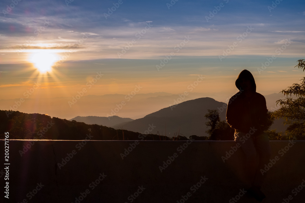 silhouette person feel with background sunrise at top moutain