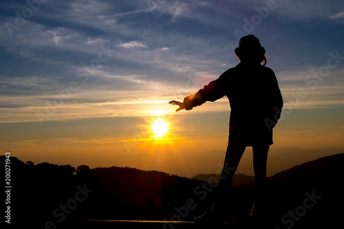 silhouette person feel with background sunrise at top moutain