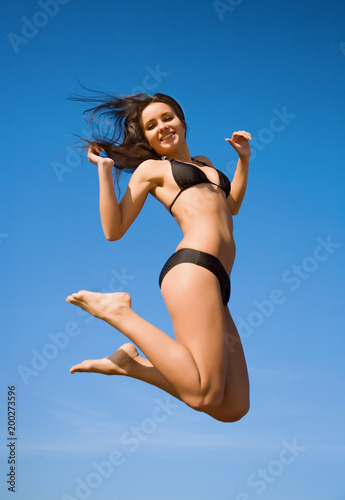 Woman in bikini jumping high © beerkoff